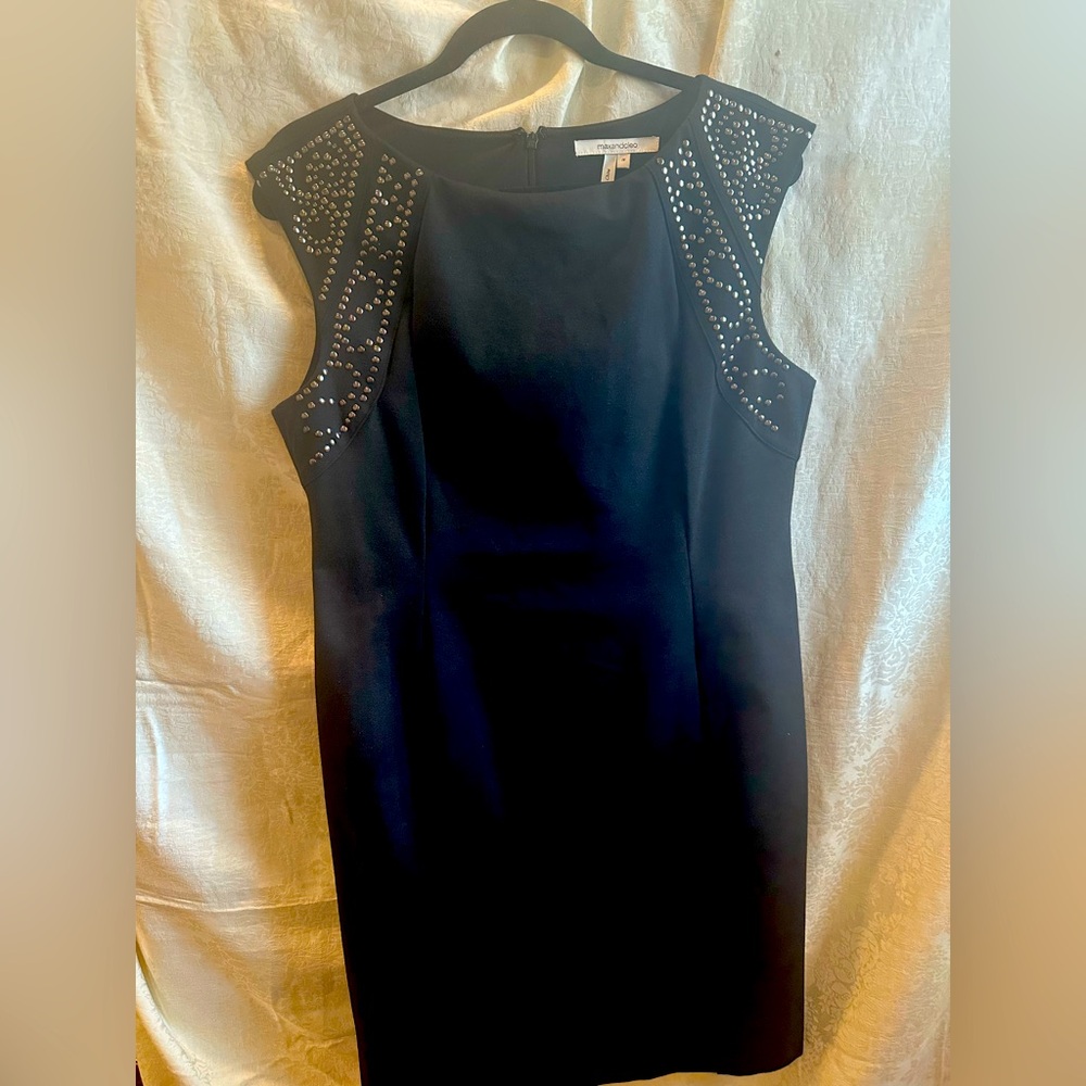 Elegant black sheath dress with beautiful studded detail. Shaped by seaming.
